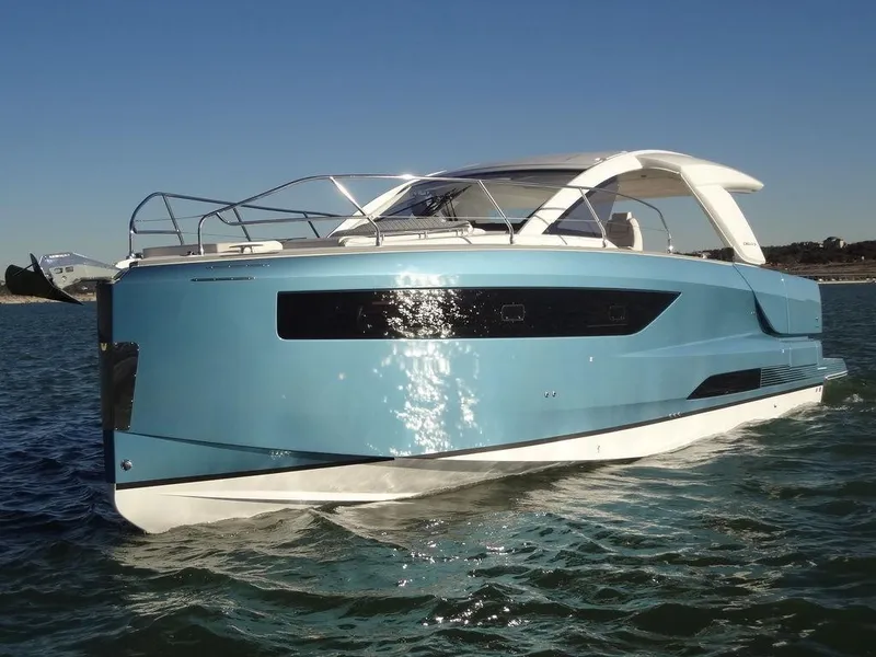 Slide: The Image of 2025 Jeanneau DB/43 OB boat on water, sleek design, blue hull, sunny day. - 30