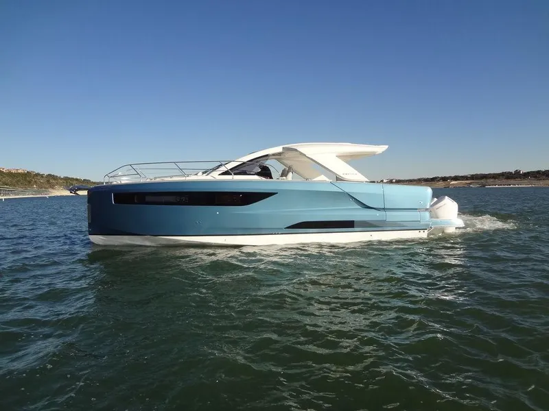 Slide: The Image of 2025 Jeanneau DB/43 OB boat cruising on open water under clear blue skies. - 33