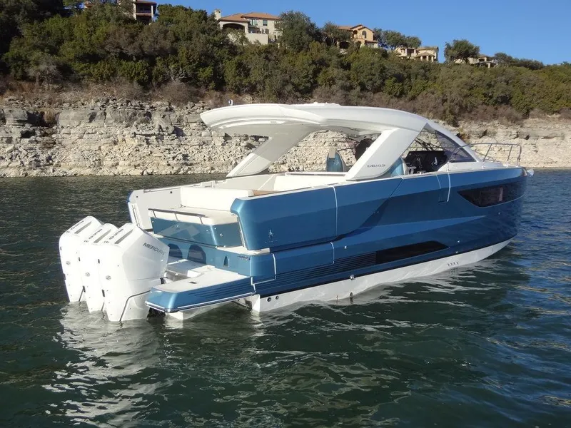 Slide: The Image of 2025 Jeanneau DB/43 OB boat on water, featuring sleek design and powerful outboard engines. - 36