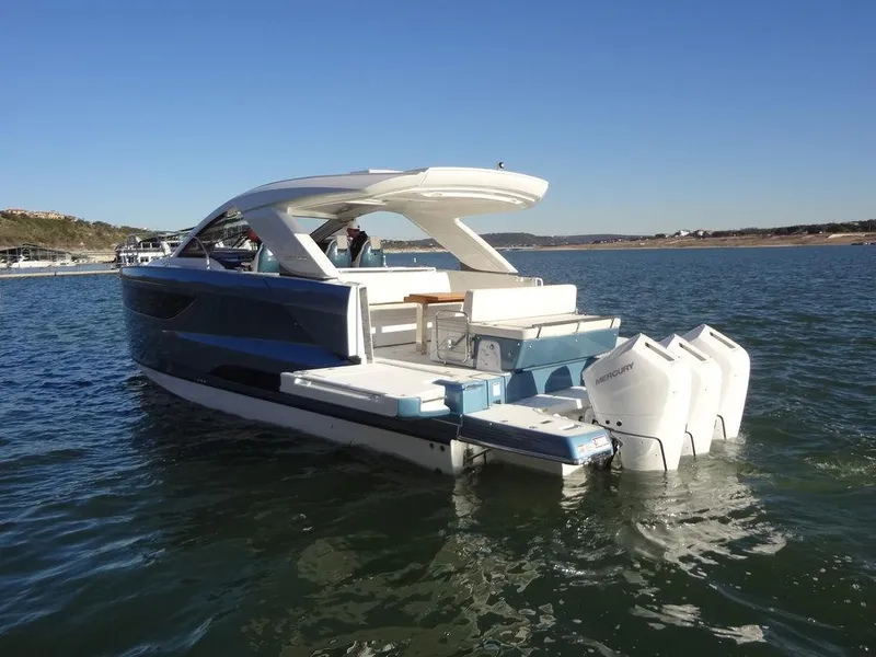 Slide: The Image of 2025 Jeanneau DB/43 OB luxury boat with triple outboard engines on a sunny day. - 38