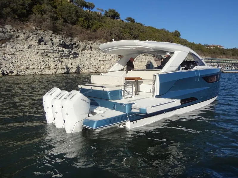 Slide: The Image of 2025 Jeanneau DB/43 OB boat with triple outboard engines on a scenic waterway. - 42