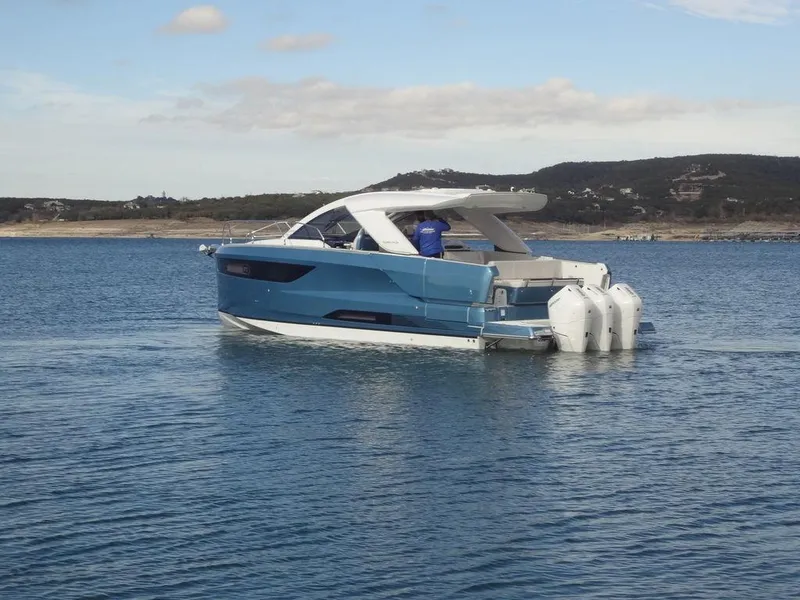 Slide: The Image of 2025 Jeanneau DB/43 OB boat on calm water, scenic background. - 5