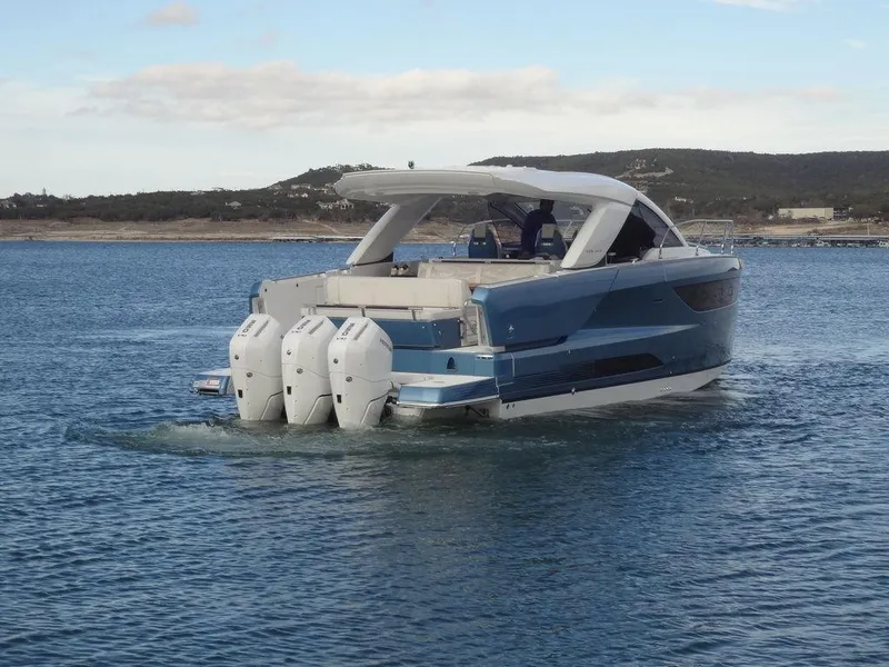 Slide: The Image of 2025 Jeanneau DB/43 OB boat cruising on a calm lake. - 9