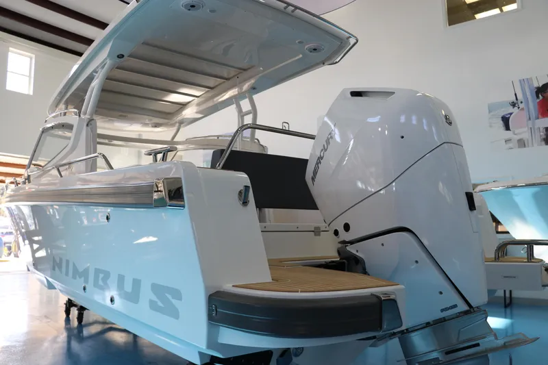 Slide: The Image of 2025 Nimbus Weekender 9 boat with sleek design and powerful outboard motor. - 10