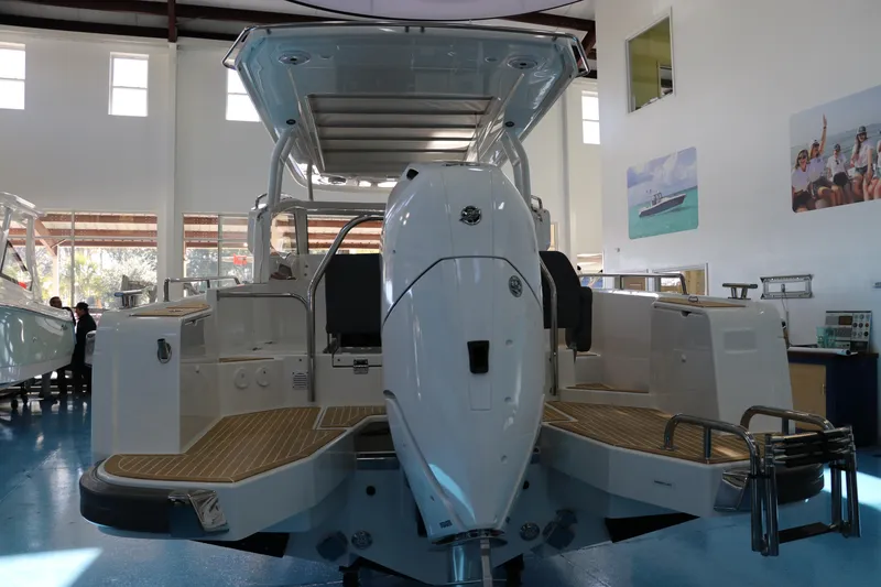 Slide: The Image of 2025 Nimbus Weekender 9 boat in showroom, rear view with outboard motor. - 11