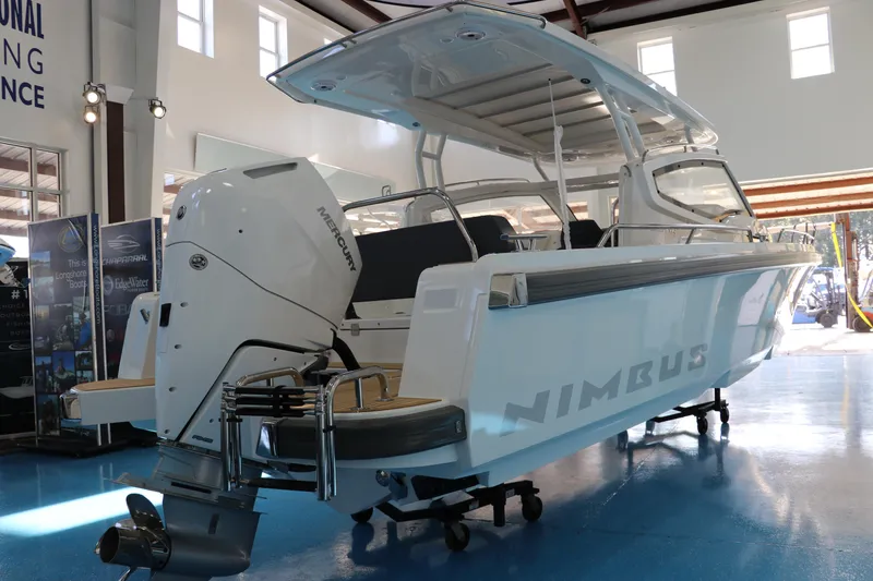 Slide: The Image of 2025 Nimbus Weekender 9 boat displayed indoors, showcasing sleek design and powerful engine. - 13