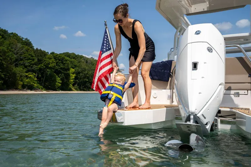 Slide: The Image of Woman and child enjoying water by a 2025 Nimbus Weekender 9 boat. - 14