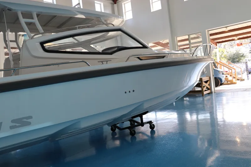 Slide: The Image of 2025 Nimbus Weekender 9 boat displayed indoors on a blue floor. - 3
