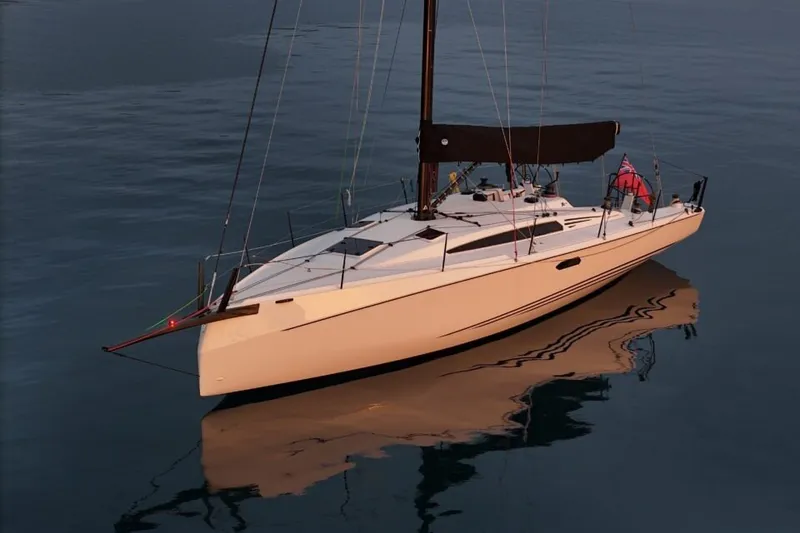 Slide: The Image of 2027 X-Yachts XR 41 sailboat on calm water at sunset. - 3