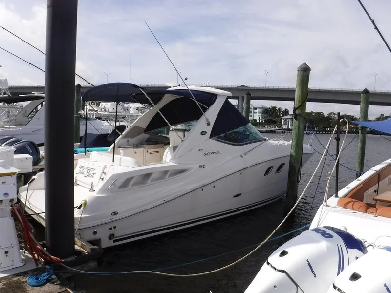 Slide: The Image of 2007 Sea Ray 310 boat docked at marina, featuring sleek design and spacious deck. - 1