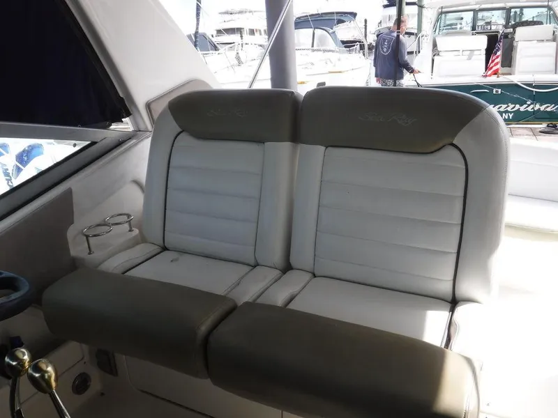Slide: The Image of 2007 Sea Ray 310 boat interior seating with cup holders, docked at marina. - 10