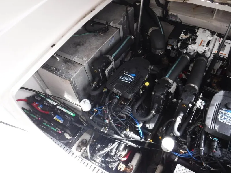 Slide: The Image of Engine compartment of a 2007 Sea Ray 310 boat, showcasing mechanical components. - 14