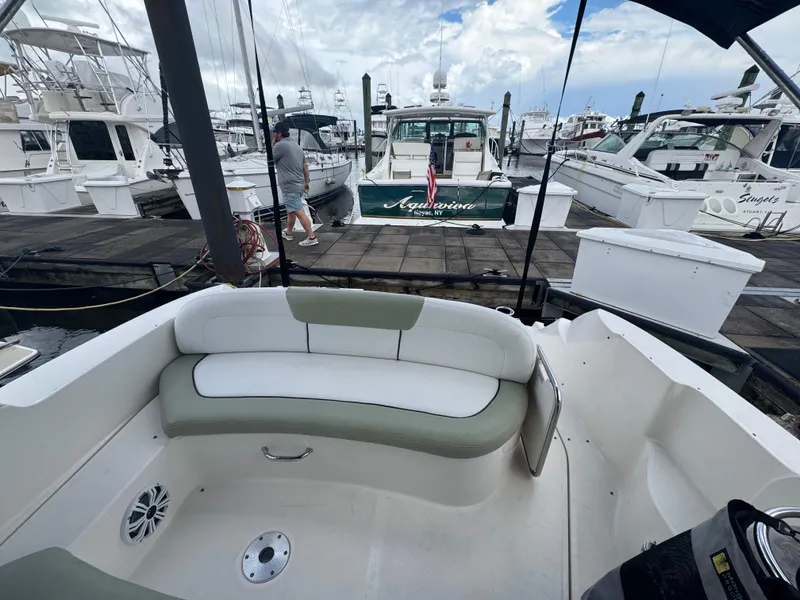 Slide: The Image of 2007 Sea Ray 310 boat interior with docked yachts in marina background. - 17