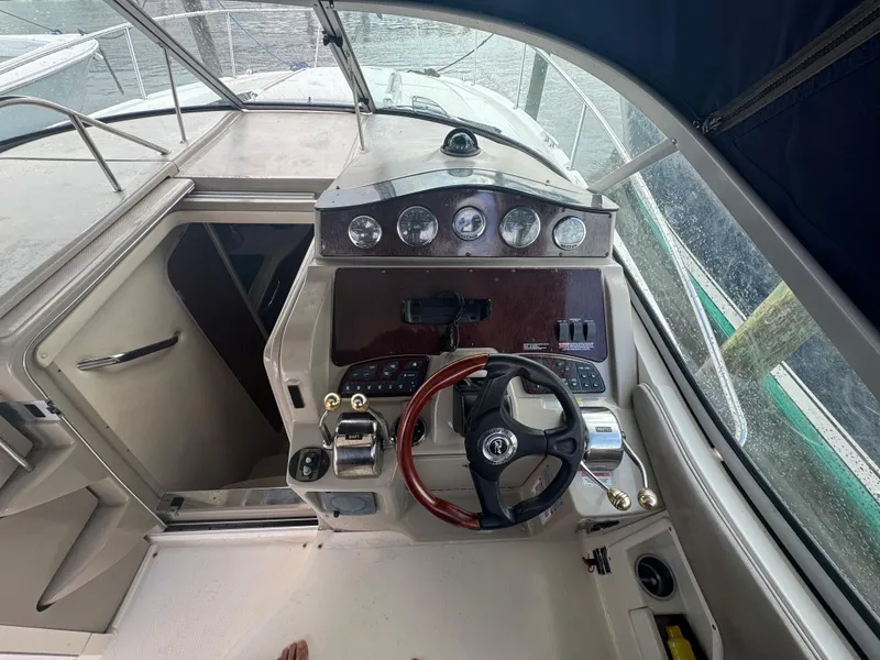 Slide: The Image of 2007 Sea Ray 310 boat cockpit with steering wheel and control panel. - 19