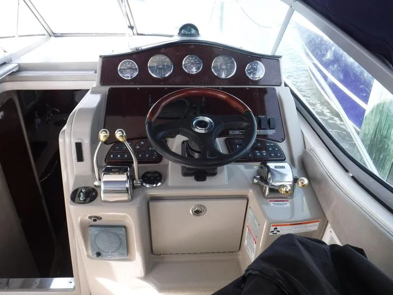 Slide: The Image of 2007 Sea Ray 310 boat cockpit with steering wheel and control panel. - 4