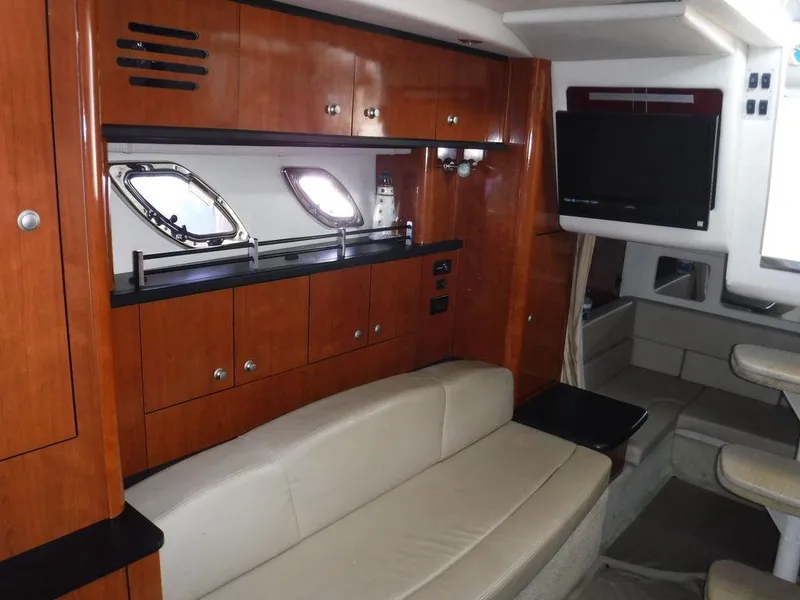 Slide: The Image of Interior of 2007 Sea Ray 310 yacht with wood cabinetry and beige seating. - 7