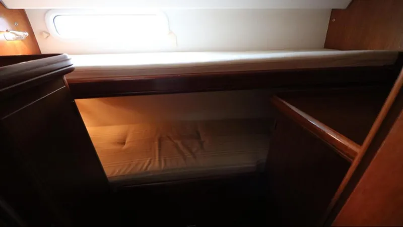 Slide: The Image of Interior cabin of 2005 Beneteau 57 yacht with bunk beds and wooden furnishings. - 10