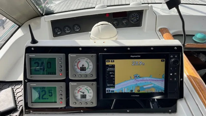 Slide: The Image of Navigation instruments on a 2005 Beneteau 57 yacht, featuring digital displays and a Raymarine chartplotter. - 12