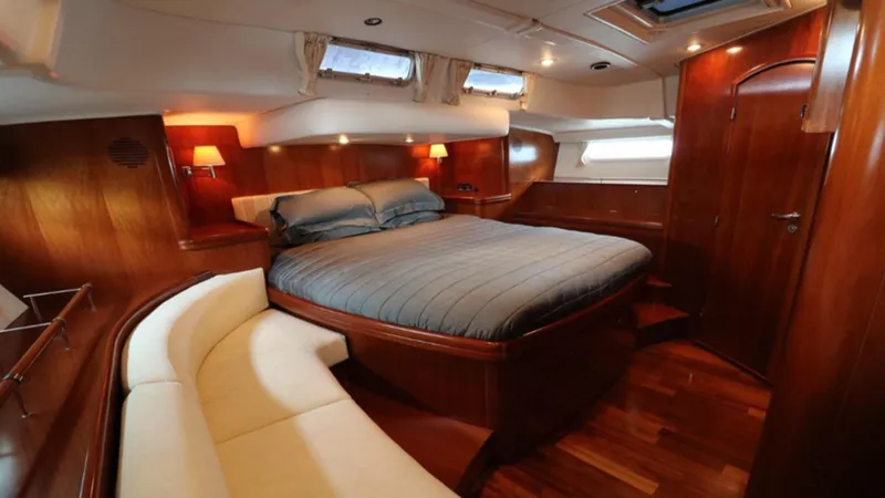 Slide: The Image of Luxurious cabin interior of a 2005 Beneteau 57 yacht with wood finishes and cozy seating. - 6