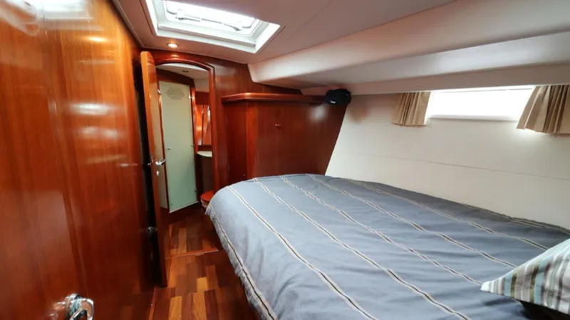 Slide: The Image of Luxurious cabin interior of a 2005 Beneteau 57 yacht with wood finish and skylight. - 8