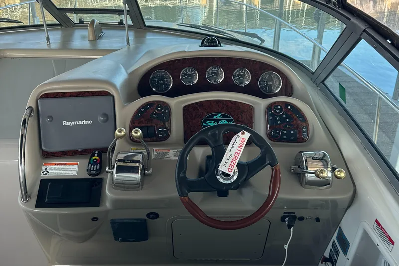 Slide: The Image of 2008 Sea Ray 340 Sundancer helm with Raymarine display and wood-accented steering wheel. - 11