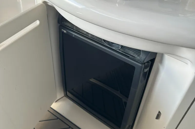 Slide: The Image of Mini fridge inside 2008 Sea Ray 340 Sundancer yacht, open cabinet view. - 13