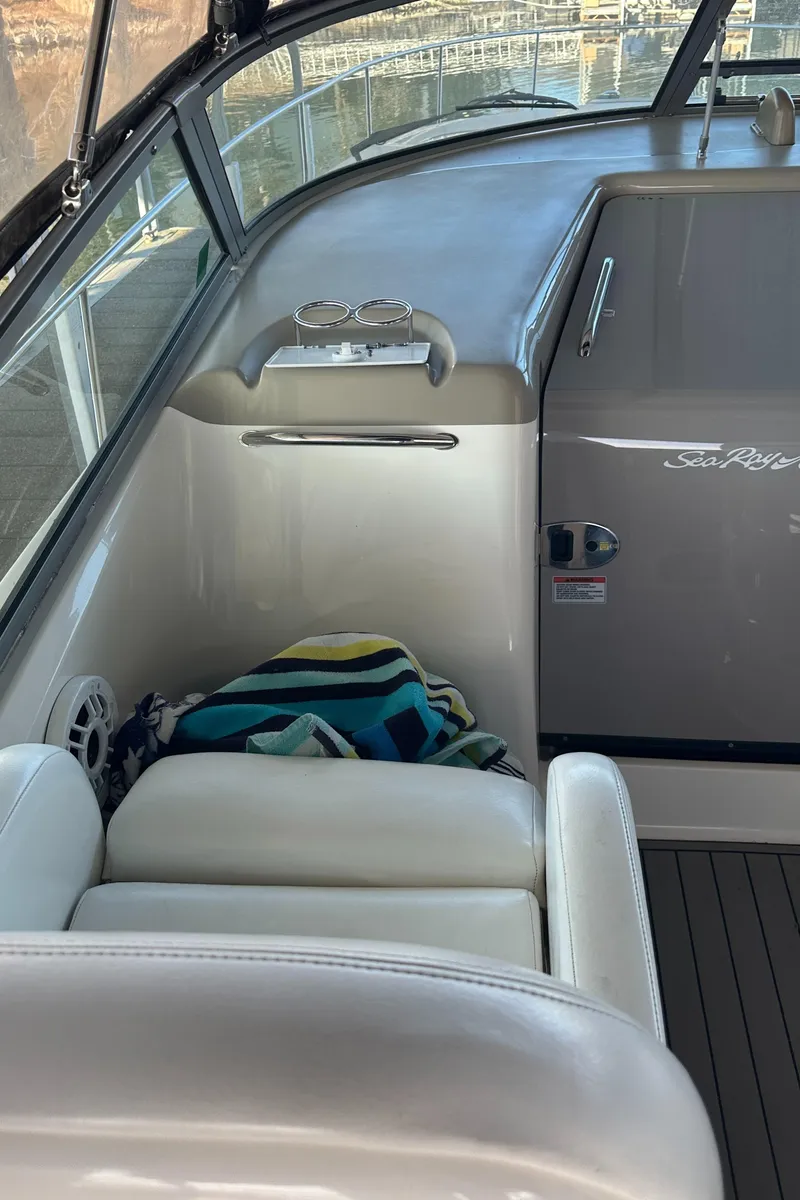 Slide: The Image of 2008 Sea Ray 340 Sundancer interior with white seating and striped towel. - 14