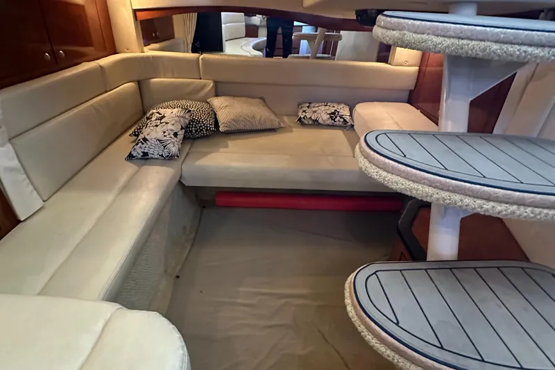 Slide: The Image of Interior of 2008 Sea Ray 340 Sundancer with beige seating and patterned cushions. - 18