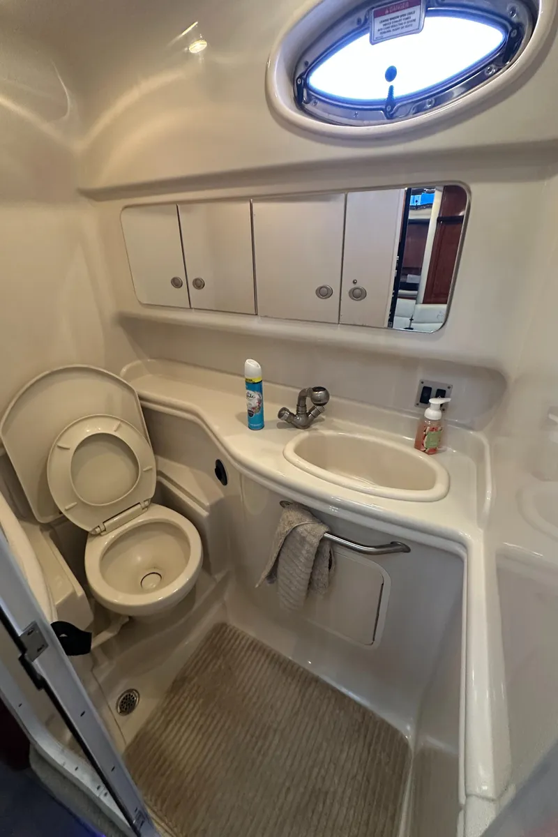 Slide: The Image of 2008 Sea Ray 340 Sundancer bathroom with sink, toilet, and storage cabinets. - 19