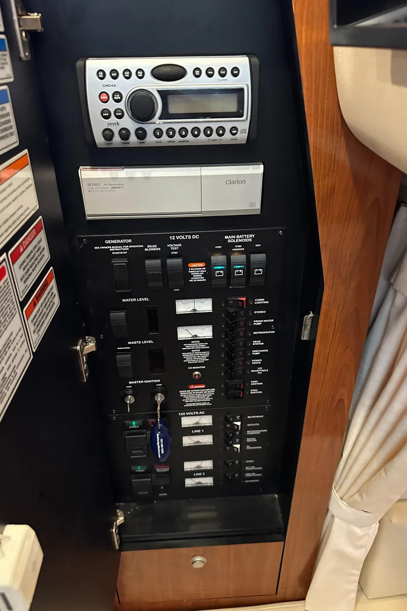 Slide: The Image of Control panel of a 2008 Sea Ray 340 Sundancer boat, featuring switches and a stereo system. - 20