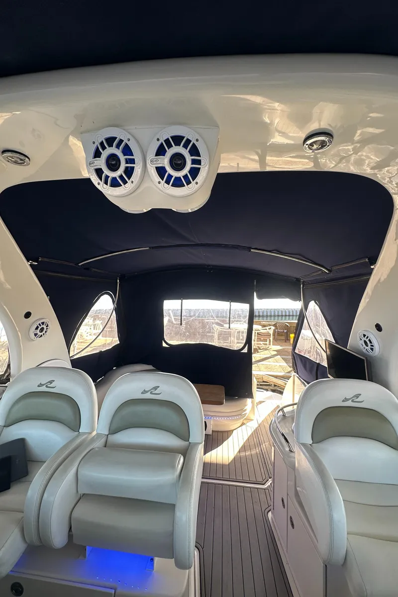 Slide: The Image of Interior of a 2008 Sea Ray 340 Sundancer boat with seating and speakers. - 24