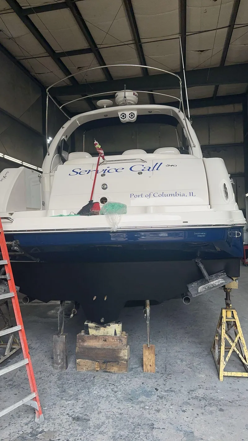 Slide: The Image of 2008 Sea Ray 340 Sundancer boat in a garage, elevated on blocks. - 29