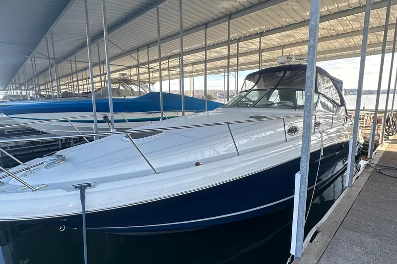 Slide: The Image of 2008 Sea Ray 340 Sundancer docked under a covered marina. - 3