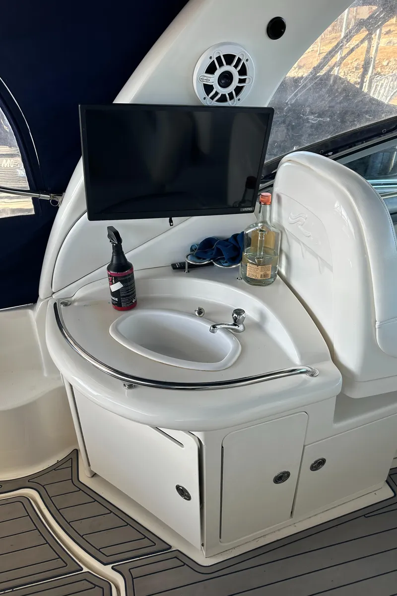 Slide: The Image of 2008 Sea Ray 340 Sundancer interior with sink, TV, and countertop accessories. - 9