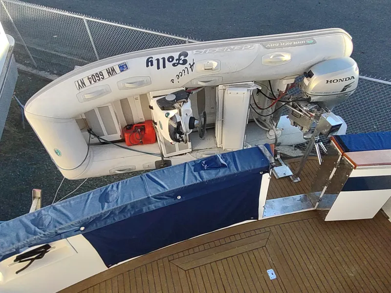 Slide: The Image of 1986 Nova 48 Cockpit Motor Yacht with inflatable boat and Honda outboard motor. - 14