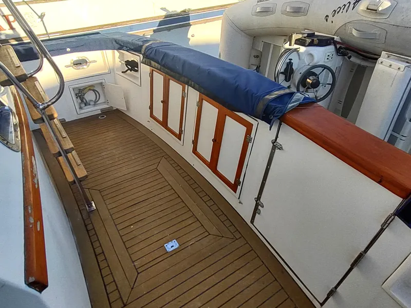 Slide: The Image of 1986 Nova 48 Cockpit Motor Yacht interior with wooden flooring and steering wheel. - 17