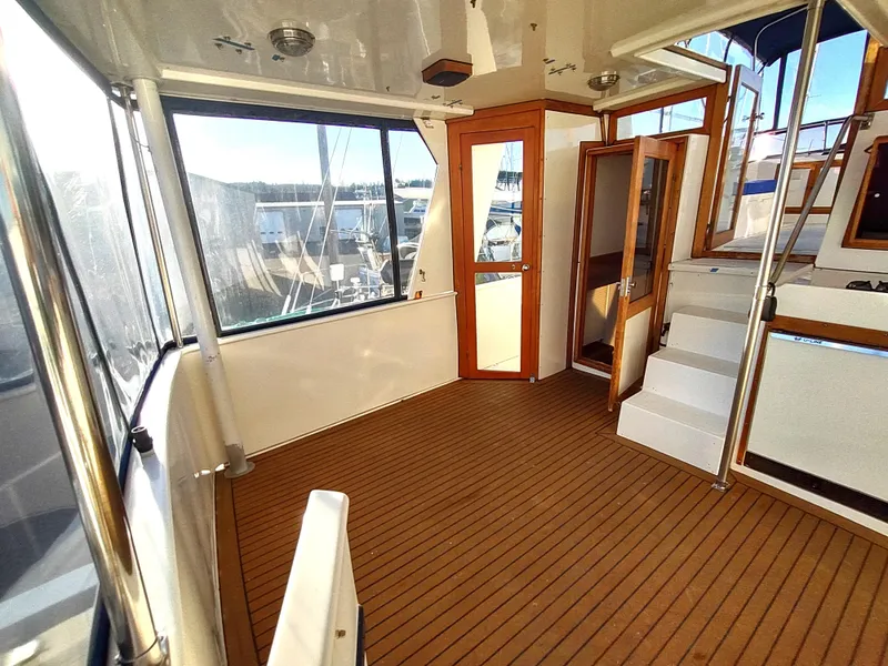 Slide: The Image of 1986 Nova 48 Cockpit Motor Yacht interior with wooden flooring and large windows. - 20