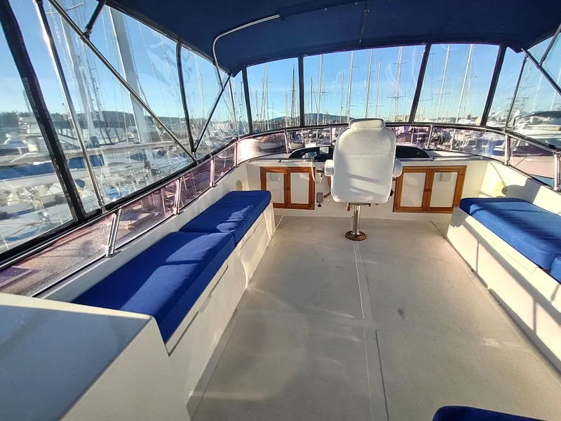 Slide: The Image of 1986 Nova 48 Cockpit Motor Yacht interior with blue seating and helm station. - 26