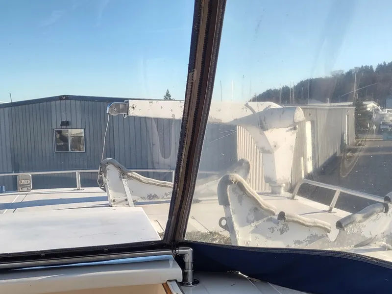 Slide: The Image of 1986 Nova 48 Cockpit Motor Yacht view from cockpit, marina background. - 33