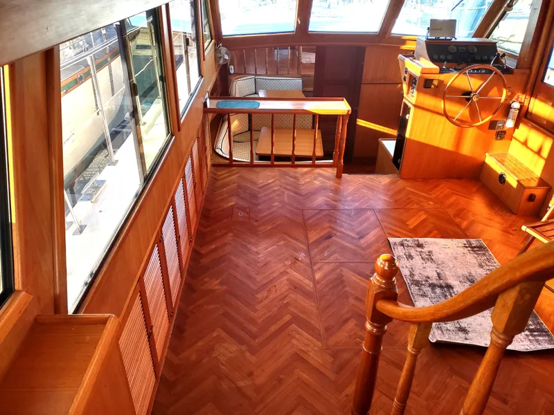 Slide: The Image of 1986 Nova 48 Cockpit Motor Yacht interior with wood flooring and helm station. - 34