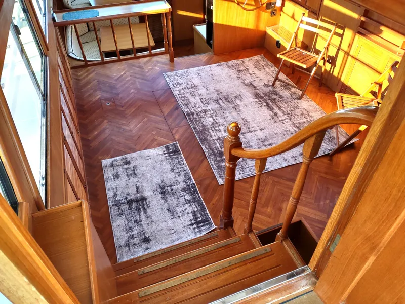 Slide: The Image of Interior of 1986 Nova 48 Cockpit Motor Yacht with wooden flooring and rugs. - 35