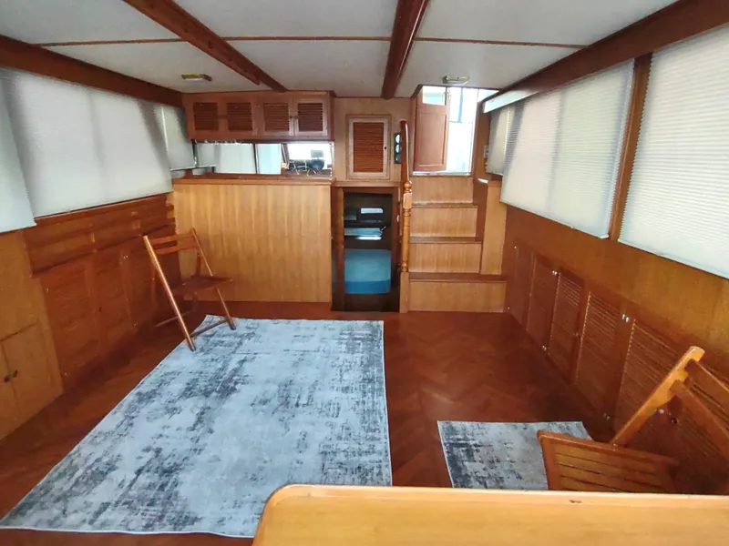 Slide: The Image of 1986 Nova 48 Cockpit Motor Yacht interior with wooden paneling and rugs. - 36