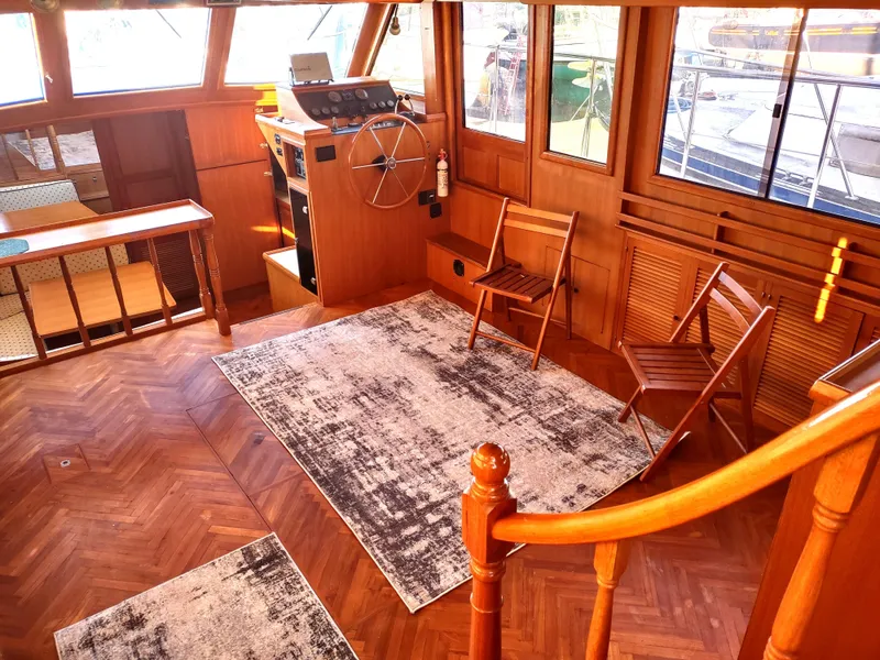 Slide: The Image of 1986 Nova 48 Cockpit Motor Yacht interior with wooden flooring and helm station. - 37