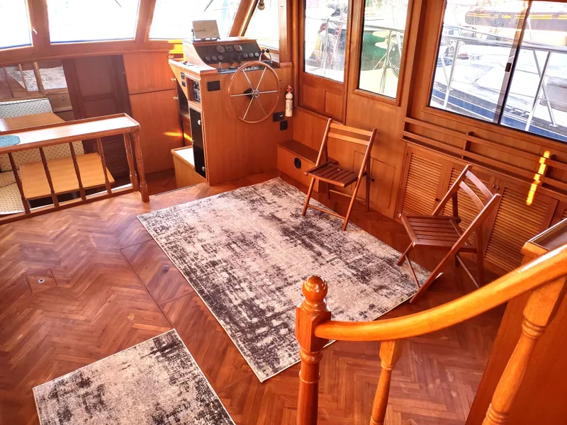Slide: The Image of 1986 Nova 48 Cockpit Motor Yacht interior with wooden flooring and helm station. - 38