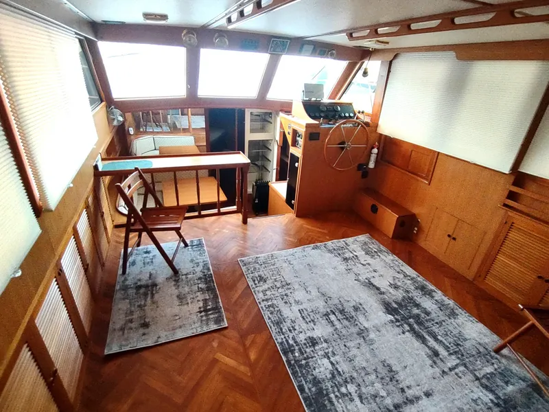 Slide: The Image of 1986 Nova 48 Cockpit Motor Yacht interior with wood paneling and helm station. - 39