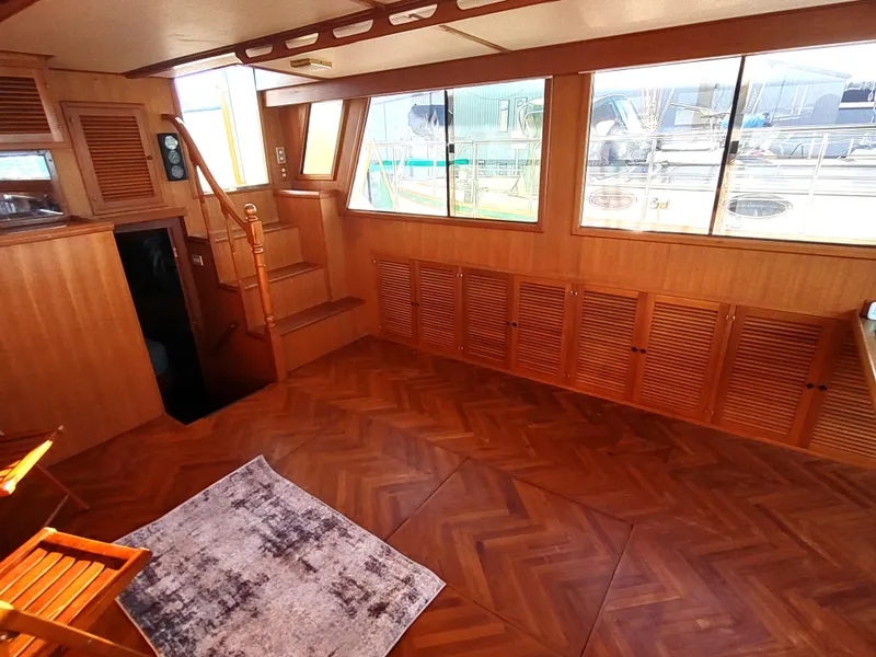 Slide: The Image of Interior of 1986 Nova 48 Cockpit Motor Yacht with wood paneling and large windows. - 43