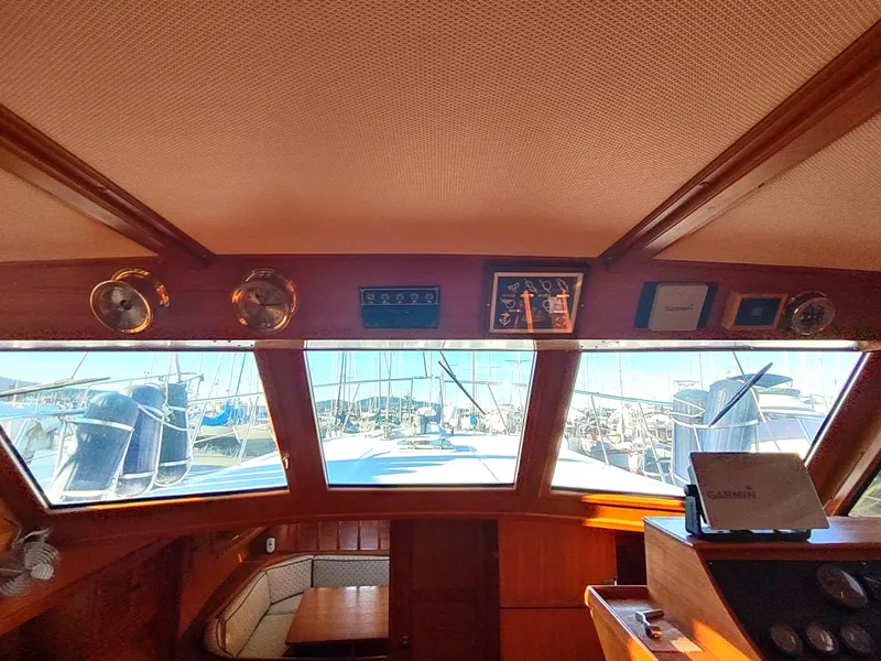 Slide: The Image of Interior view of 1986 Nova 48 Cockpit Motor Yacht, showcasing helm and windows. - 46