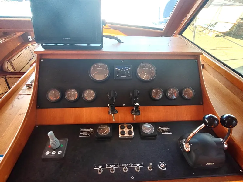Slide: The Image of Control panel of a 1986 Nova 48 Cockpit Motor Yacht with gauges and levers. - 47