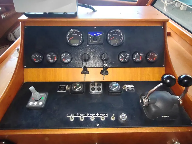 Slide: The Image of Control panel of a 1986 Nova 48 Cockpit Motor Yacht with gauges and levers. - 48