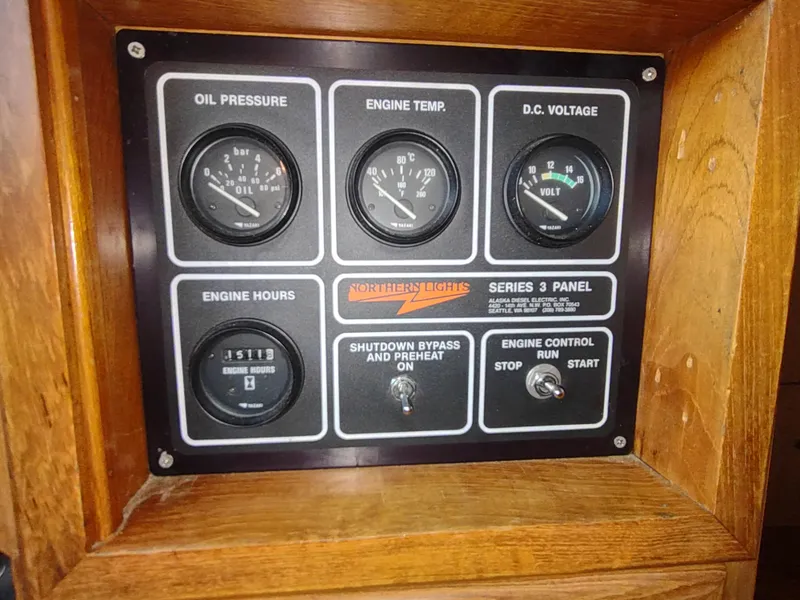 Slide: The Image of Control panel of a 1986 Nova 48 Cockpit Motor Yacht with gauges and switches. - 49